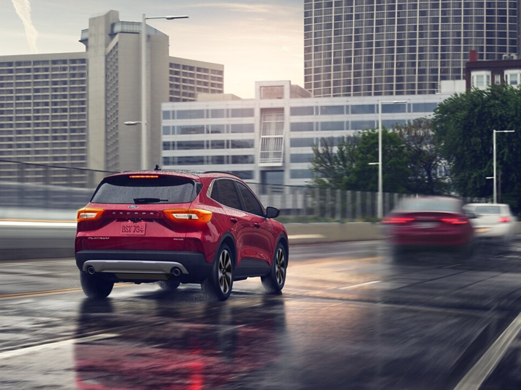 The 2025 Ford Escape drives on a rain-soaked road through the city. Shop for your new 2025 Ford Escape at Cleveland Ford near Chattanooga.